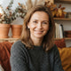A smiling Polish woman looking at the camera, representing a happy customer in a professional portrait.