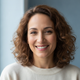 Close-up portrait of a smiling adult, conveying happiness and trust.